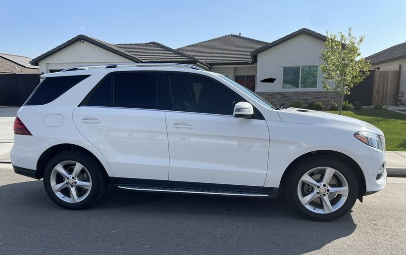 White Mercedes SUV after tint, side view