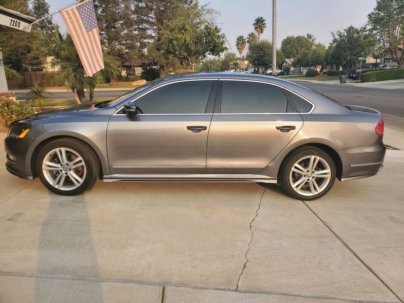 Grey VW Passat side view with tinted windows